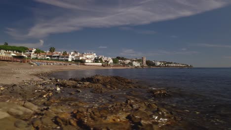 Beach-and-town-coastline-in-4K-moving-into-the-sea