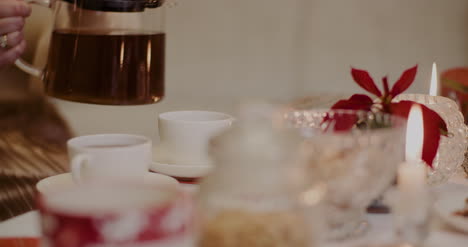 Woman-Pouring-Black-Coffee-In-Cup-At-Home