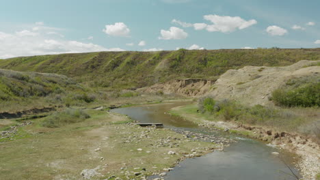 aerial above tranquil stream of fresh water, river in saskatchewan, canada