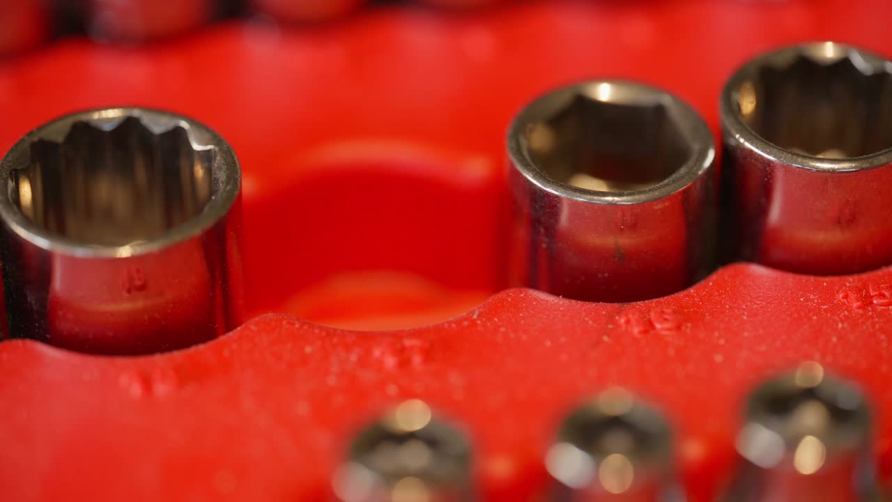 male fingers pluck a size 17mm metric socket from the plastic tool holder