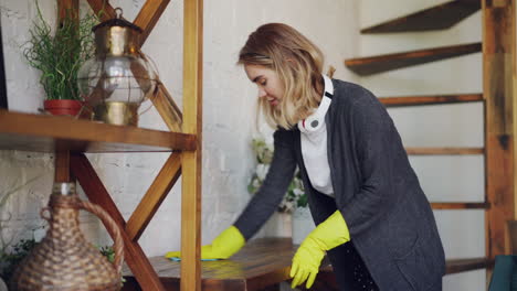 woman cleaning wooden shelves