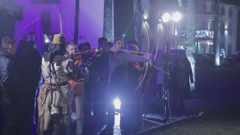 people aims a bow at a target. vinnitsa, ukraine, march 2017: people is trying aims a bow at a target