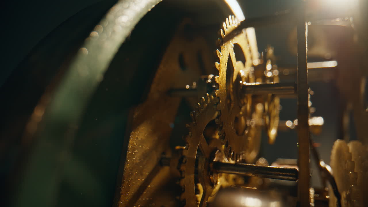 Inner cogs working inside traditional time device closeup. Metal wheels rotating