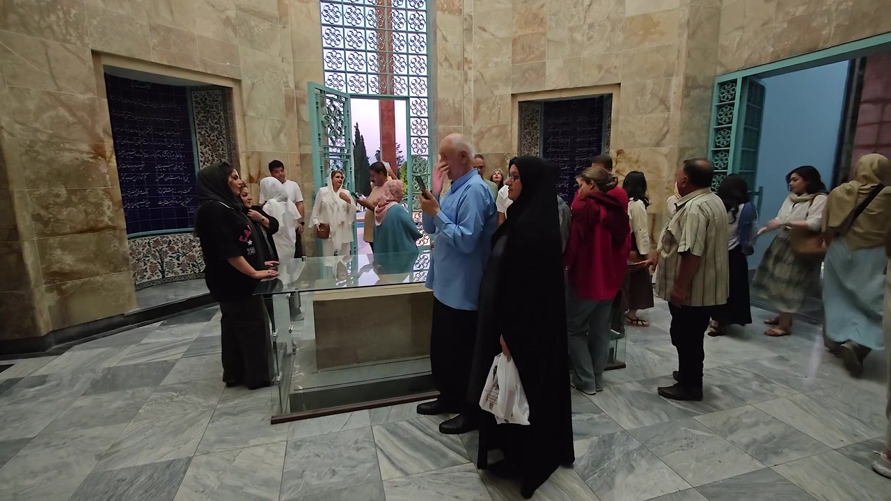 Gruppo di visitatori che osserva una tomba in un mausoleo