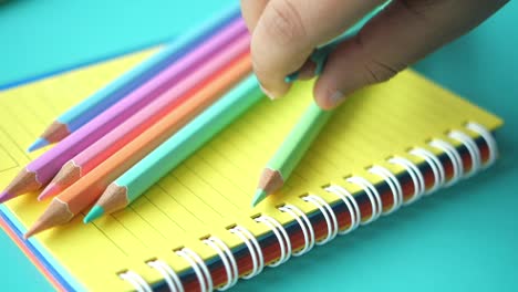 colorful pencils on a spiral notebook