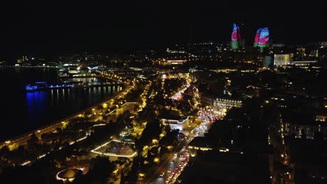 Night-aerial:-Heavy-street-traffic-on-Caspian-waterfront,-Azerbaijan