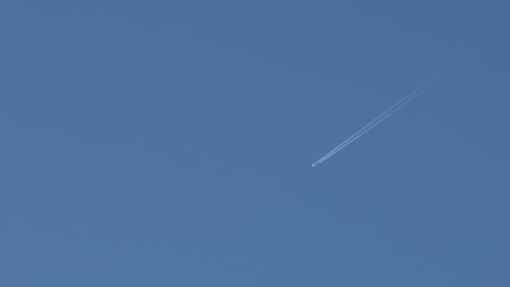 aeroplane with contrail vapor trails clear blue sky australia, victoria, gippsland, maffra daytime wide shot