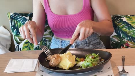 woman eating chicken dinner