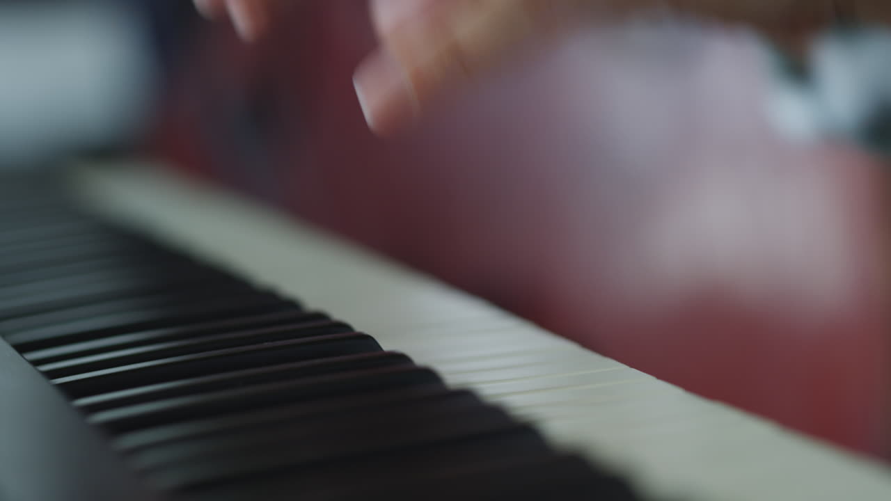 Hands playing the piano keys