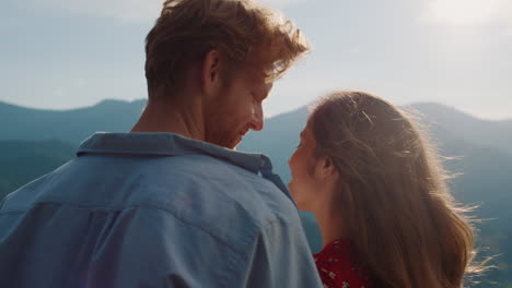 smiling couple look mountains landscape view. happy lovers enjoy hike outdoors.