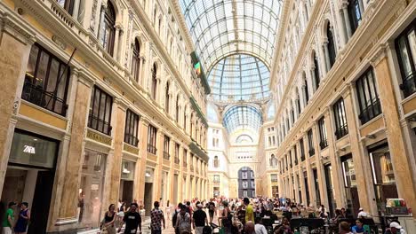 people walking inside historic shopping gallery