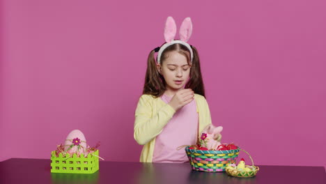 exhausted little child decorating festive ornament for easter sunday celebration