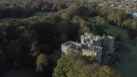 Rotating-aerial-orbits-rebuilt-Irish-castle-with-lush-green-grounds