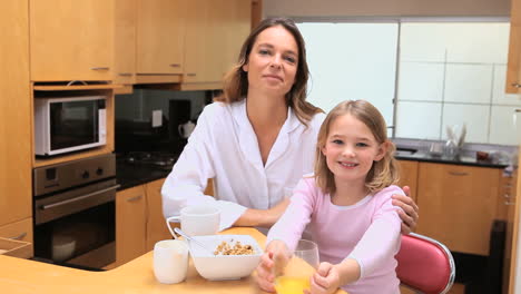 peaceful mother and daughter drinking