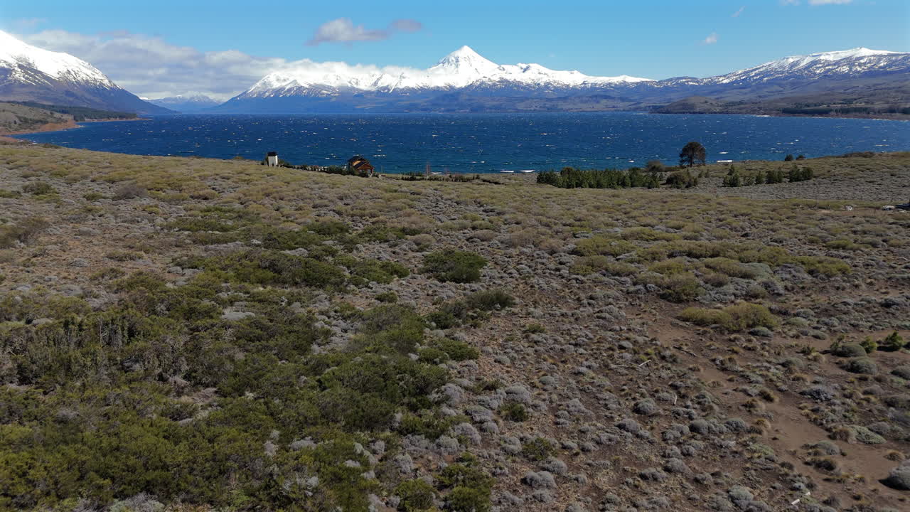 Stunning view of Huechulafquen lake shoreline and snow covered Lanín Volcano in Patagonia, Neuquén, Argentina