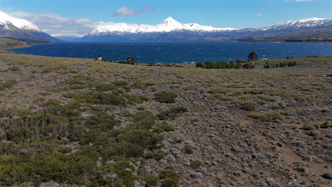 stunning view of huechulafquen lake shoreline and snow covered lanín volcano in patagonia, neuquén, argentina