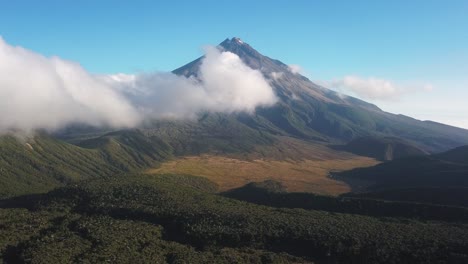 slow motion leaving a valley from an epic mountain volcano