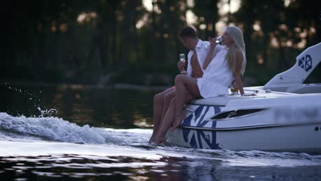 lovely charming couple relaxing on floating boat. romantic boating on river