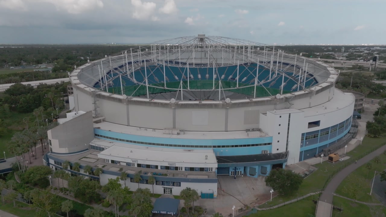 Roof damage on Tropicana Field in St. Petersburg, Florida with drone video tilting up.