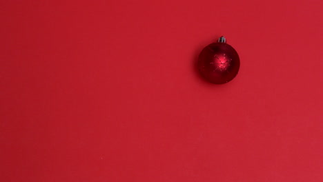 red christmas bauble spinning on red background