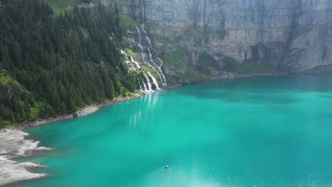mountain lake between the giant mountains on a cloudy and moody morning. it is captured in the swiss alps at kandersteg with the dji mavic pro 2.