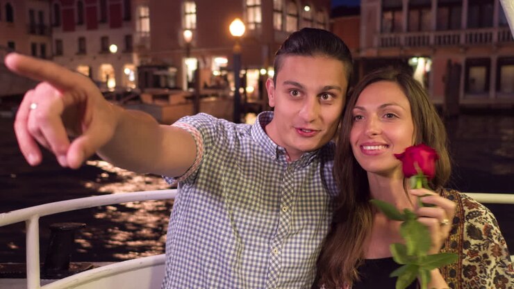 Couple enjoying a romantic gondola ride in Venice at night
