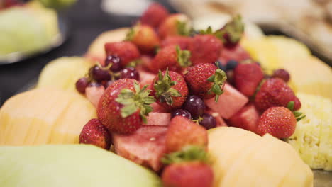 close up of fresh strawberries and pineapple on a table