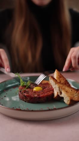 woman eating a beef tartare