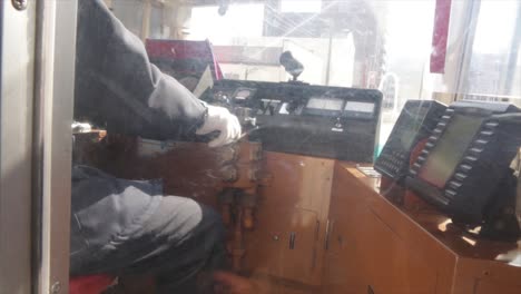 operator in the cockpit driving a tram in hakodate, japan