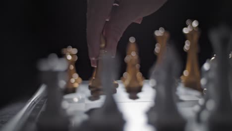 sliding shot of a hand moving a bishop across the chessboard