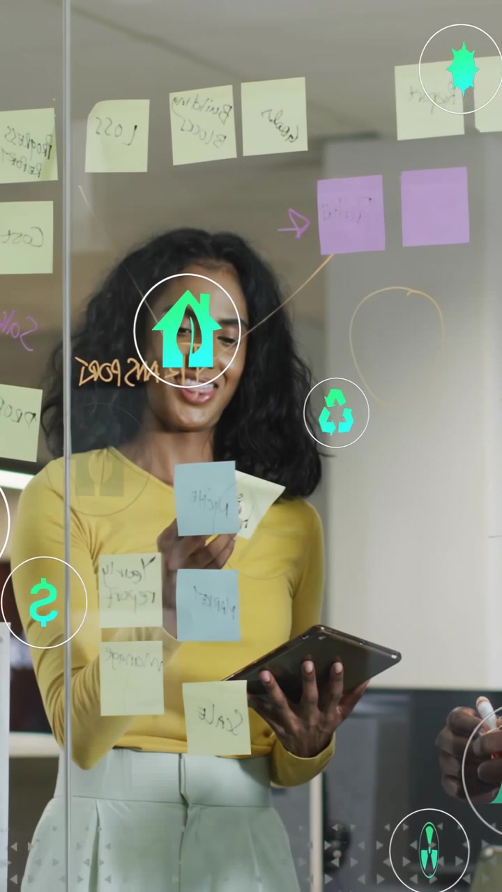 Vertical video: Woman placing notes on glass, tapping tablet and showing overlay icons for business