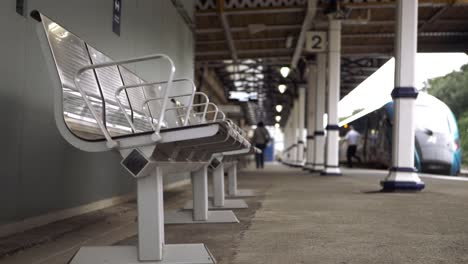 Passengers-leaving-train-at-station-platform-wide-shot