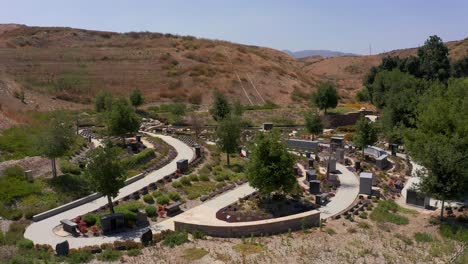 Aerial-close-up-panning-shot-of-a-tranquil-nature-garden-at-a-mortuary-in-California