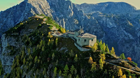 kehlsteinhaus on top of rocky alp mountains, aerial orbit view