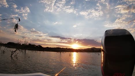 fishing from the back of a bass boat with a stunning sunset in the distance