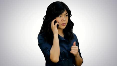 Businesswoman in blue suit talking on the cell phone on white background