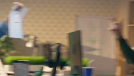 carefree guys joking together office room closeup. man throwing paper at partner