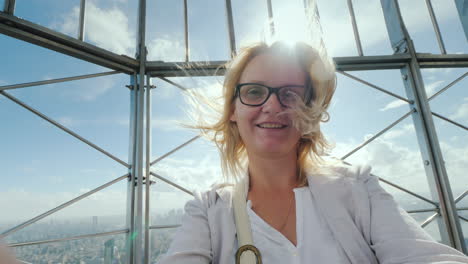 Portrait-Of-A-Happy-Woman-Shooting-Herself-On-Video-Against-The-Background-Of-The-City-Of-New-York