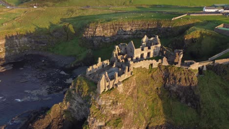 Aerial-view-of-Dunluce-Castle-on-a-sunny-evening,-County-Antrim,-Northern-Ireland