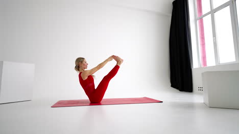 young woman shows yoga or pilates exercises. young attractive woman practicing yoga in studio. girl shows different poses for yoga in white background. healthy lifestyle yoga in my heart sports