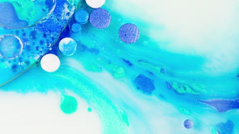 Watercolor-ink-tablets-floating-in-blue-and-white-liquid-color