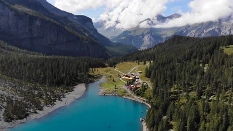 aerial: oeschinen lake among rocky mountains in the alps