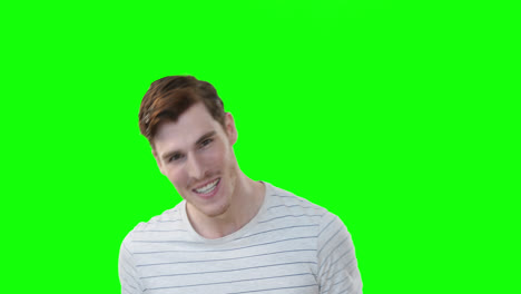 caucasian man smiling at camera on green background