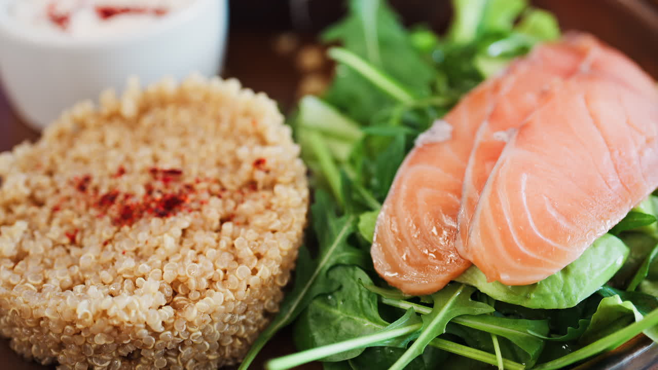 Close up of a quinoa salad with salmon and spinach at a restaurant