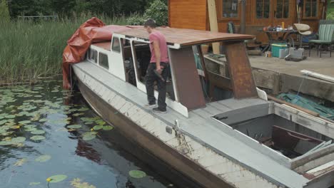 young carpenter walking across wooden ww2 1940 seaplane tender boat