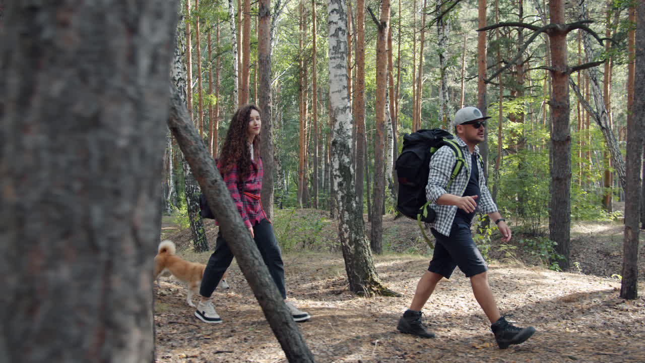 Friends Hiking in the Forest with a Dog