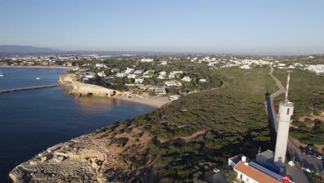 steep cliffs and beaches in ferragudo, charming ponta do altar lighthouse, stunning coast flyover