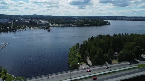 aerial flies over tourism boat on river under bridge in tampere finland