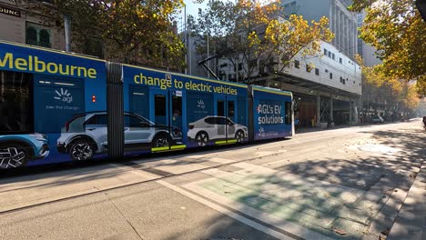 electric tram passing through melbourne city street