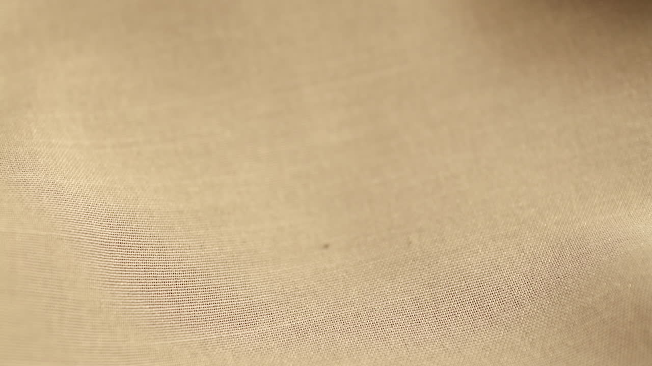 Wedding Gold Rings dropped on white cloth background. Jewelry for Weddings.